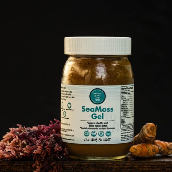 A jar of seaweed oil next to some flowers.